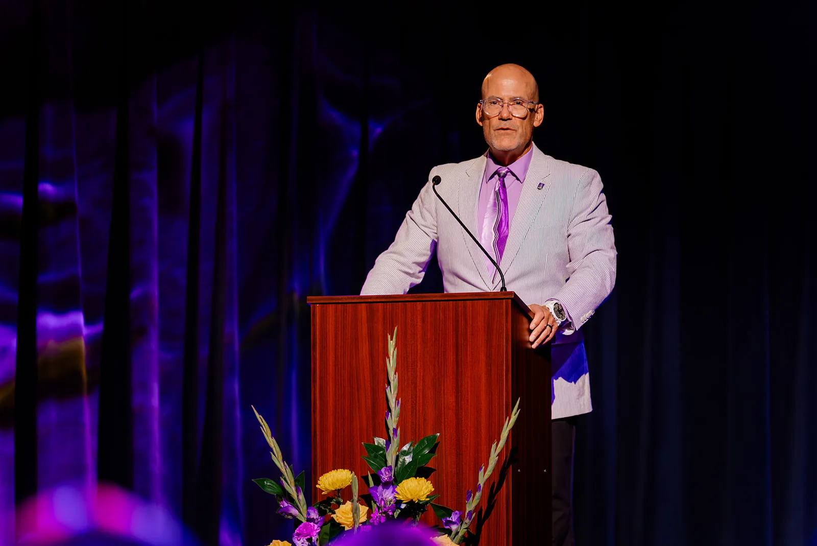 A presenter speaks at a podium