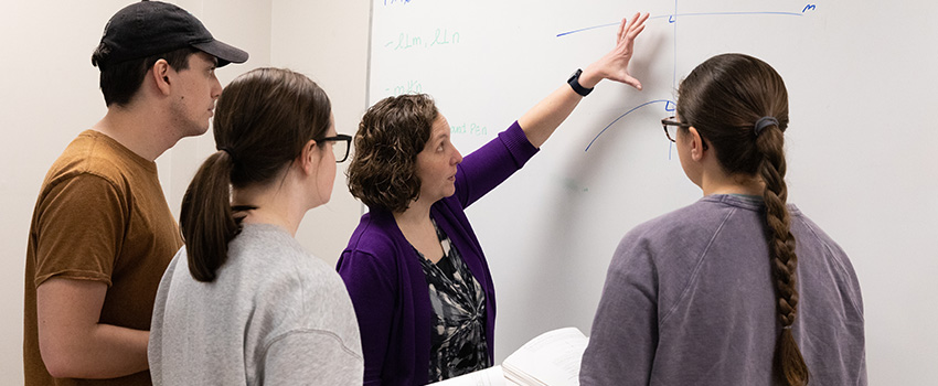 teacher showing students how to work a math problem