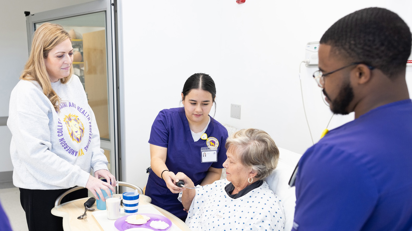 people around a senior lady in hospital bed
