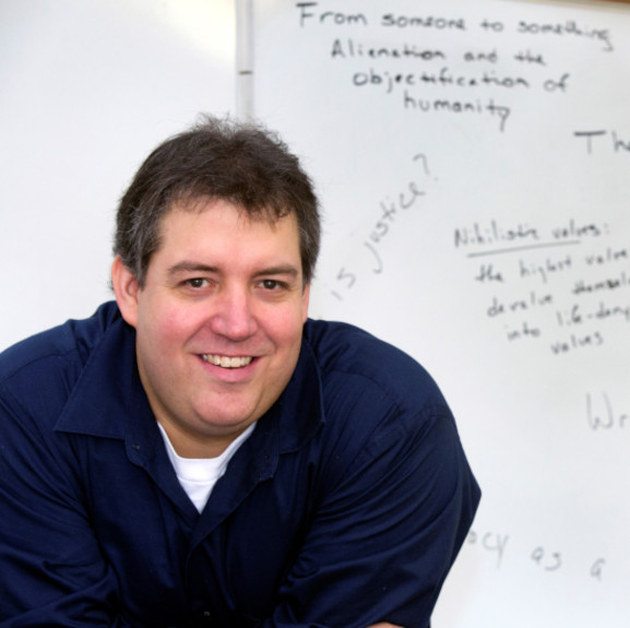 Dr. Fitzsimmons in front of a lesson in progress.